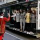 Photo of Tom Sweeney greeting trolly riders in San Francisco