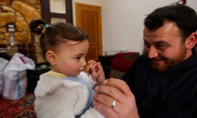 Photo of Abdullah Mohammed with his daughter, three-year-old Salwa inside a house he recently fled to, near the Syrian-Turkish border, in Sarmada, Syria