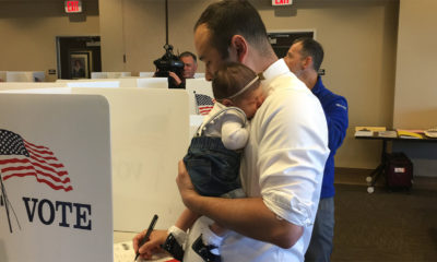 Photo of Andrew Janz voting with his daughter