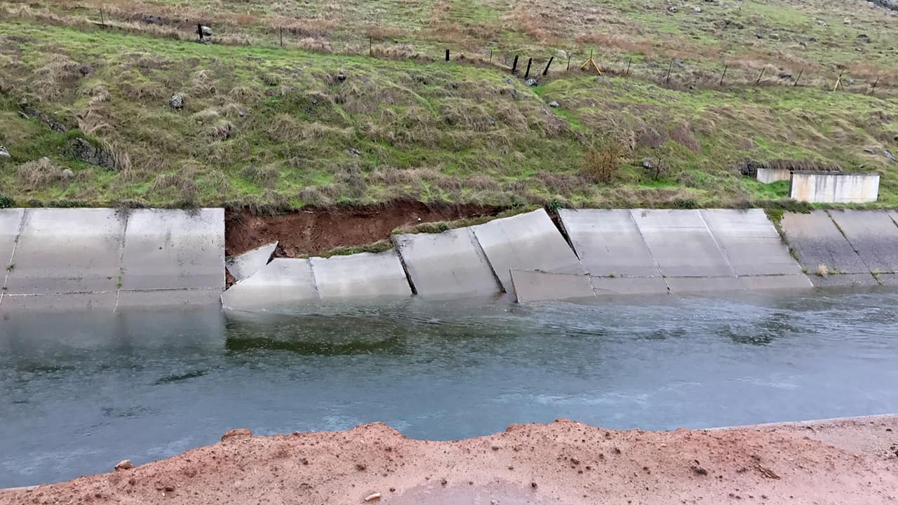 Photo of a canal with a damaged wall