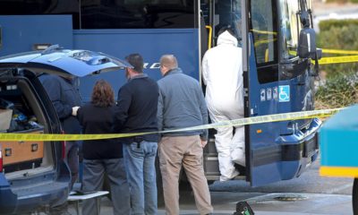 Photo of investigators outside of a Greyhound bus