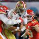 Photo of Kansas City Chiefs' Frank Clark, left, trying to tackle San Francisco 49ers' quarterback Jimmy Garoppolo