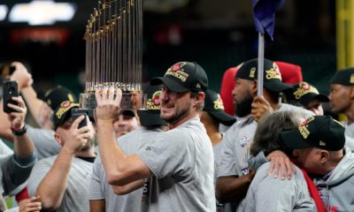 Photo of Washington Nationals starting pitcher Max Scherzer with the trophy after Game 7 of the baseball World Series against the Houston Astros in Houston