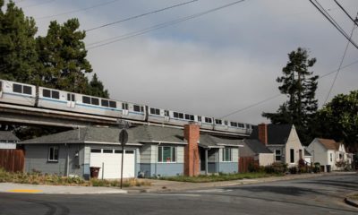 Photo of a BART train running about housing in Albany