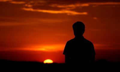 Photo of a man watching a sunset