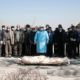 Photo of mourners praying over the body of former politburo official in the Revolutionary Guard Farzad Tazari