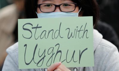 Photo of a man holding a sign during a rally to show support for Uighurs and their fight for human rights in Hong Kong