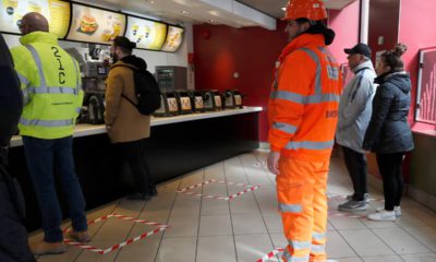 Photo of people standing in marked places