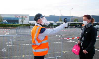 Photo of a man taking a woman's temperature