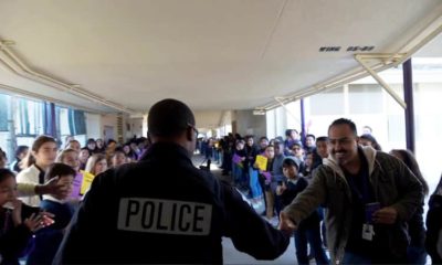 Photo of campus resource officer Martin saying goodbye to students at Cooper Academy in Fresno, Californiaooo