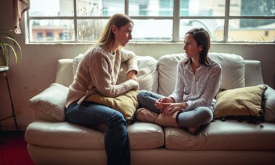 Image of a mother and child talking on a couch