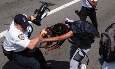 Photo of protesters struggling with an officer