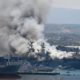 Photo of smoke rising from the USS Bonhomme Richard at Naval Base San Diego