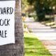 Photo of a Harvard Block Sale sign stuck to a tree in Fresno, California