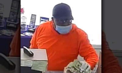 Image of man wearing orange shirt and blue surgical mask robbing a bank in Easton, CaliforniaMan weari