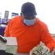 Image of man wearing orange shirt and blue surgical mask robbing a bank in Easton, CaliforniaMan weari