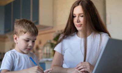 Photo of a caring mom helping her son with distance learning during the pandemic