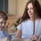 Photo of a caring mom helping her son with distance learning during the pandemic