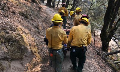 Photo of a woman being carried out after falling while hiking along Willow Creek on Saturday, Aug. 22, 2020, in Madera County, California