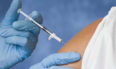 Photo of a flu shot vaccination going into a patient's arm