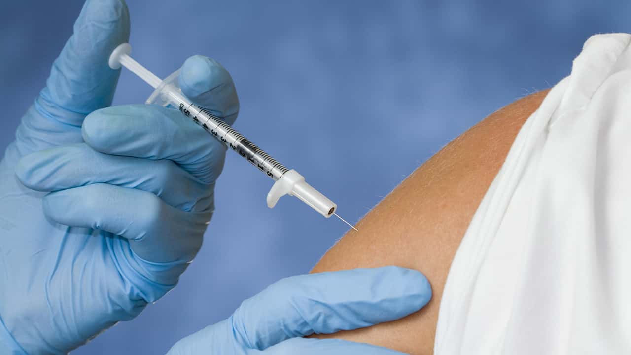 Photo of a flu shot vaccination going into a patient's arm