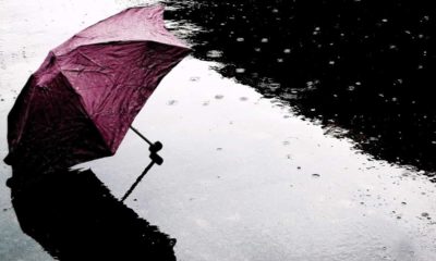 Photo of an umbrella on the ground during a rain shower